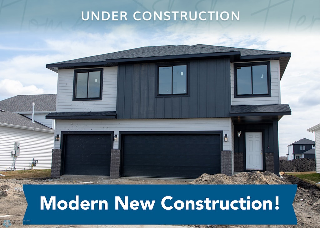 6856 Meadow View Dr S, Fargo, ND 58104 - view of front of home featuring board and batten siding, an attached garage, brick siding, and roof with shingles