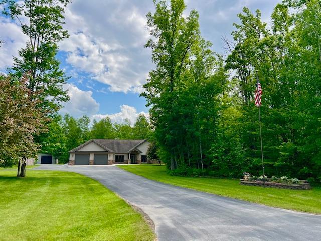 23567 Timber Trail Dr, Bemidji, MN 56601 - ranch-style house with an attached garage, a front yard, and asphalt driveway