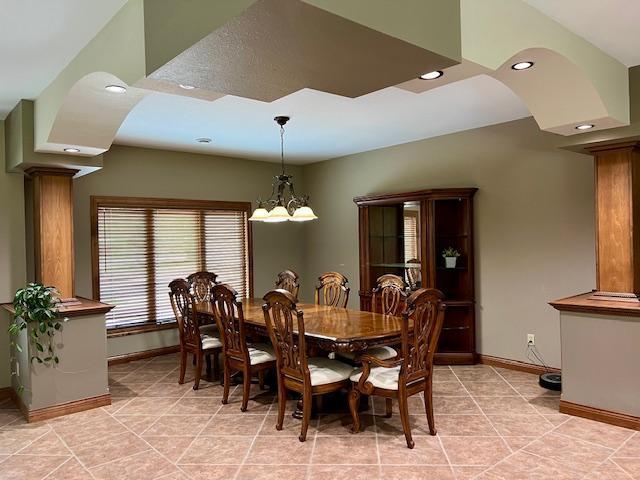 23567 Timber Trail Dr, Bemidji, MN 56601 - dining area featuring baseboards, decorative columns, recessed lighting, a chandelier, and light tile patterned floors