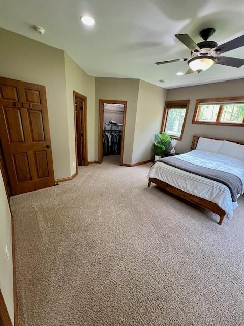23567 Timber Trail Dr, Bemidji, MN 56601 - bedroom featuring light colored carpet, baseboards, recessed lighting, a ceiling fan, and a closet