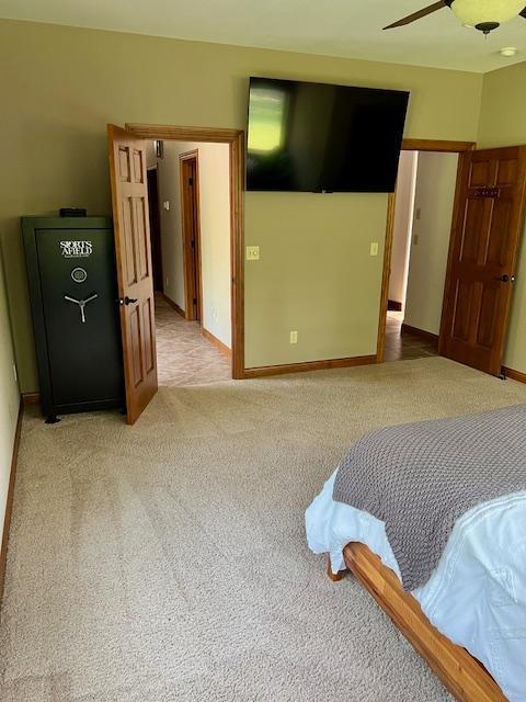 23567 Timber Trail Dr, Bemidji, MN 56601 - bedroom featuring light colored carpet, a ceiling fan, and baseboards