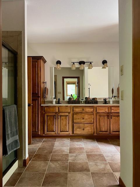 23567 Timber Trail Dr, Bemidji, MN 56601 - bathroom with double vanity and a shower with shower door