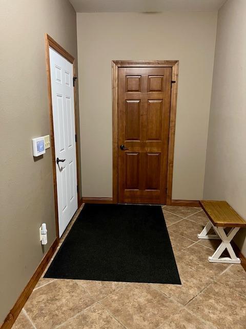23567 Timber Trail Dr, Bemidji, MN 56601 - corridor featuring tile patterned flooring and baseboards