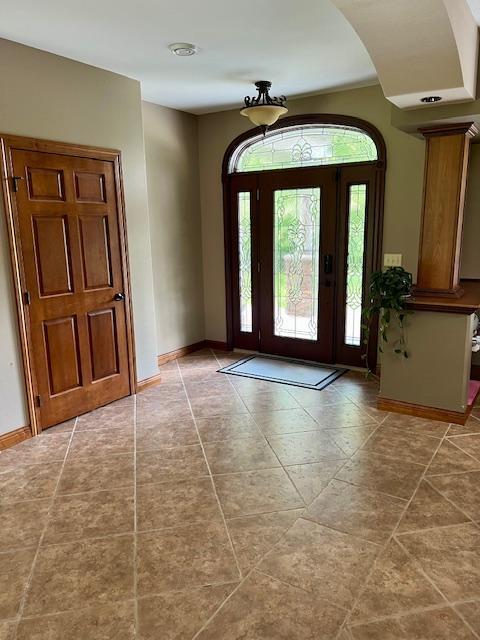 23567 Timber Trail Dr, Bemidji, MN 56601 - entryway featuring plenty of natural light, baseboards, tile patterned floors, and arched walkways