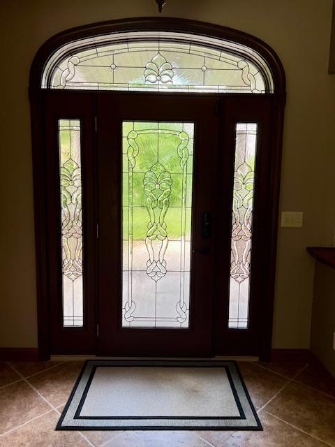 23567 Timber Trail Dr, Bemidji, MN 56601 - tiled entryway featuring baseboards and plenty of natural light
