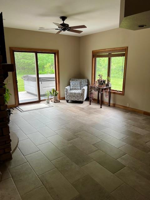 23567 Timber Trail Dr, Bemidji, MN 56601 - sitting room featuring a ceiling fan and baseboards