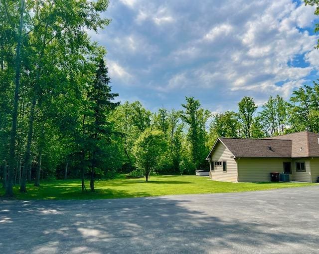 23567 Timber Trail Dr, Bemidji, MN 56601 - view of side of home with a yard