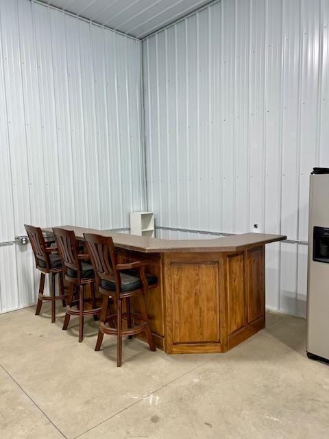 23567 Timber Trail Dr, Bemidji, MN 56601 - indoor dry bar with stainless steel fridge with ice dispenser and concrete floors