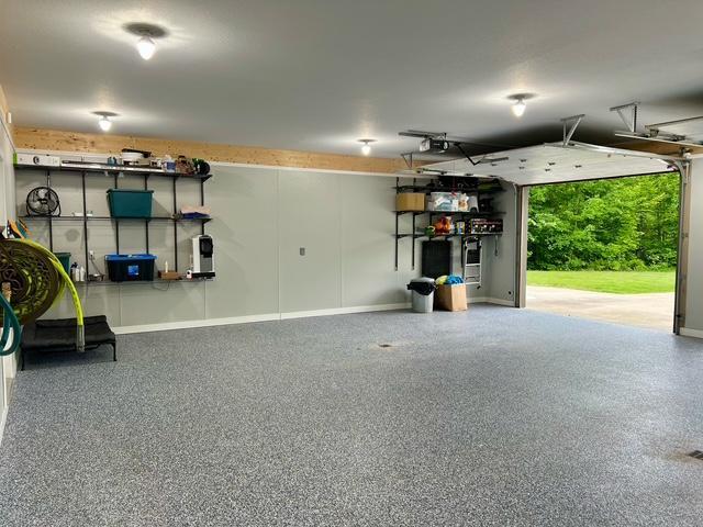 23567 Timber Trail Dr, Bemidji, MN 56601 - garage featuring baseboards and a garage door opener