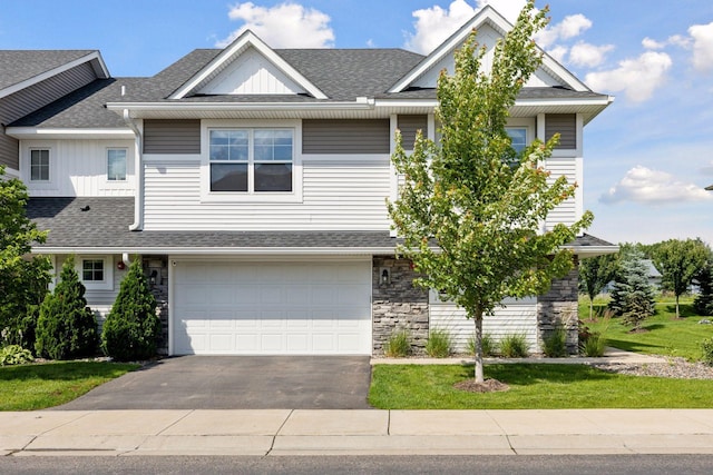 13824 102nd Pl N, Maple Grove, MN 55369 - view of front of property featuring driveway, a shingled roof, stone siding, an attached garage, and board and batten siding