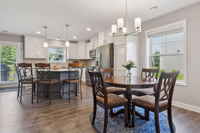 13824 102nd Pl N, Maple Grove, MN 55369 - dining space featuring dark wood finished floors, a chandelier, and recessed lighting