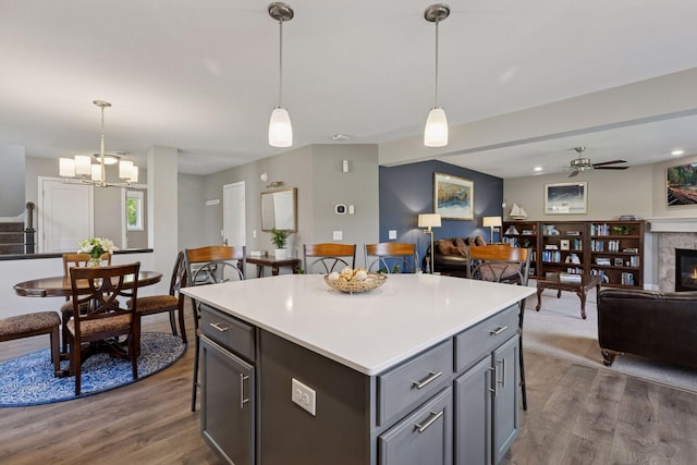 13824 102nd Pl N, Maple Grove, MN 55369 - kitchen featuring open floor plan, dark wood finished floors, pendant lighting, ceiling fan, and a kitchen island