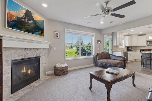 13824 102nd Pl N, Maple Grove, MN 55369 - living room with a ceiling fan, a tiled fireplace, light colored carpet, and recessed lighting
