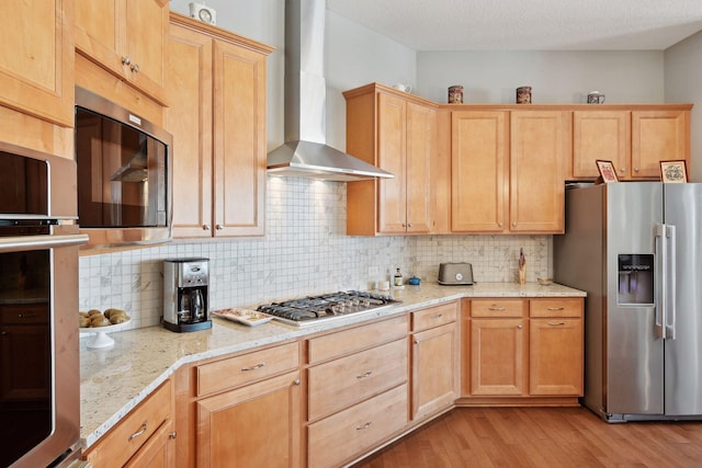 19086 100th Pl N, Maple Grove, MN 55311 - kitchen with appliances with stainless steel finishes, wall chimney range hood, light wood-style floors, decorative backsplash, and a textured ceiling