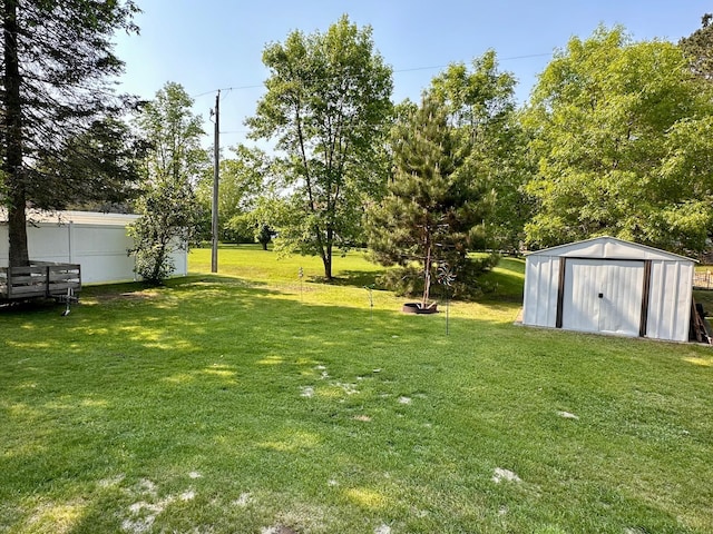 303 Goad Dr, Wrenshall, MN 55797 - view of grassy yard featuring a storage unit