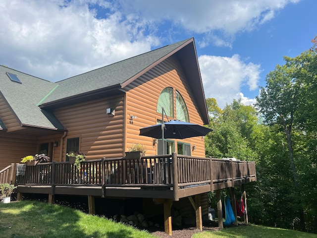 454 Wagon Wheel Dr SE Unit 17, Ten Lake Twp, MN 56601 - rear view of house featuring a shingled roof, a wooden deck, and faux log siding