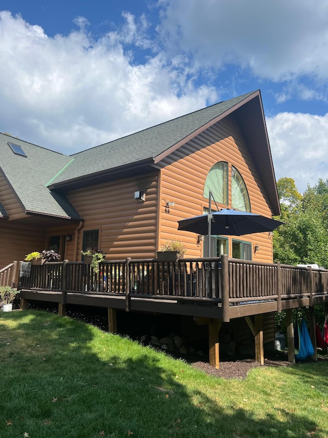 454 Wagon Wheel Dr SE Unit 17, Ten Lake Twp, MN 56601 - back of house featuring faux log siding, a deck, and a lawn
