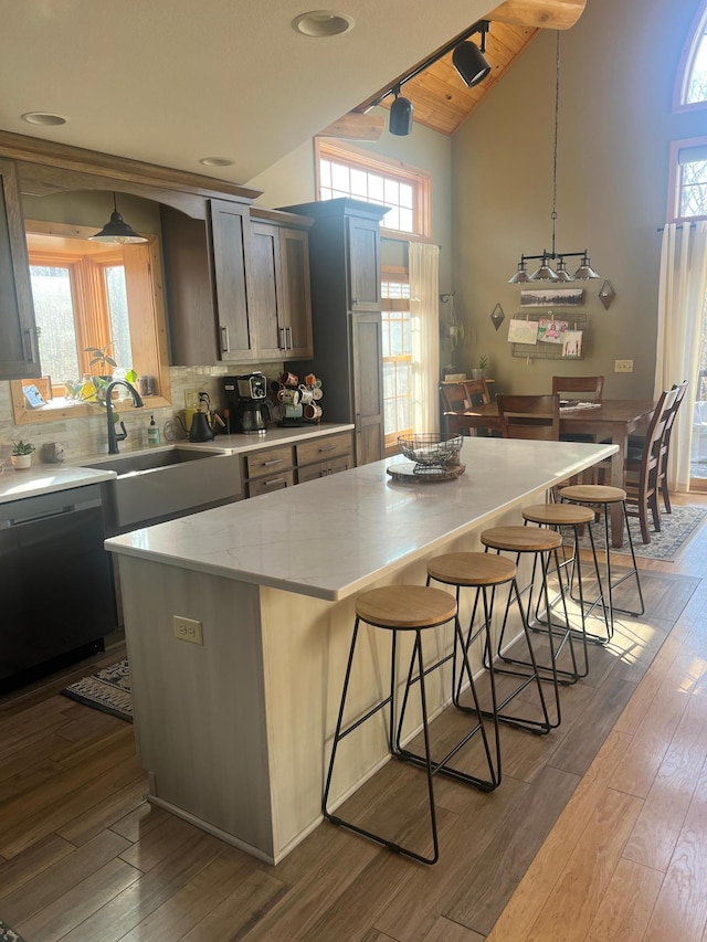 454 Wagon Wheel Dr SE Unit 17, Ten Lake Twp, MN 56601 - kitchen with dishwashing machine, a breakfast bar, a spacious island, high vaulted ceiling, and healthy amount of natural light