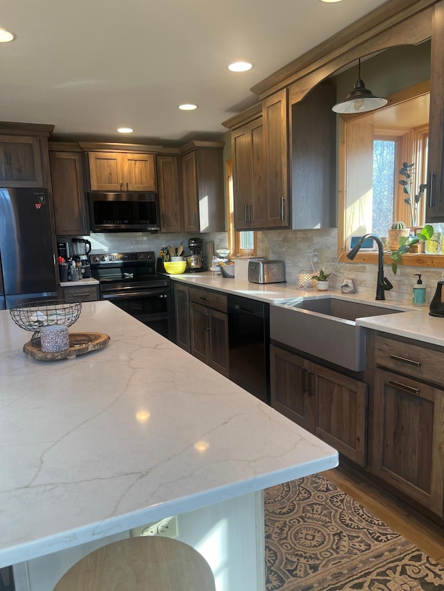 454 Wagon Wheel Dr SE Unit 17, Ten Lake Twp, MN 56601 - kitchen featuring black appliances, backsplash, light stone counters, recessed lighting, and wood finished floors