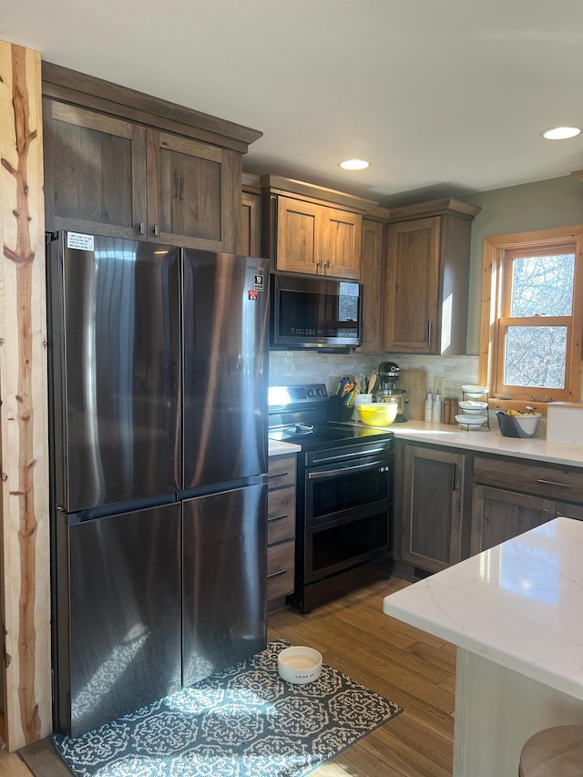 454 Wagon Wheel Dr SE Unit 17, Ten Lake Twp, MN 56601 - kitchen with stainless steel appliances, decorative backsplash, wood finished floors, and recessed lighting