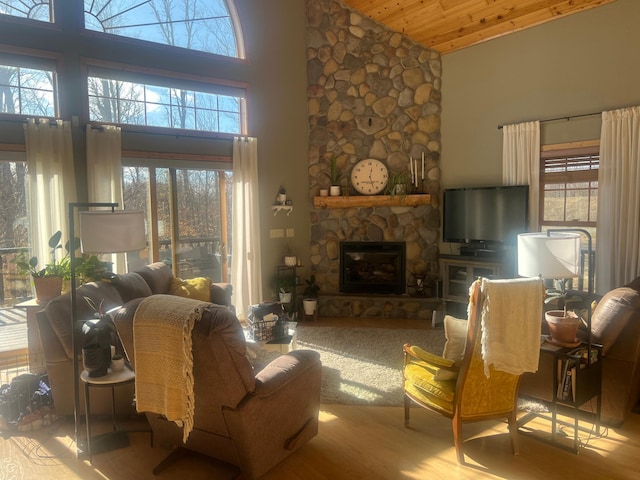 454 Wagon Wheel Dr SE Unit 17, Ten Lake Twp, MN 56601 - living room featuring high vaulted ceiling, plenty of natural light, wood finished floors, a fireplace, and wooden ceiling