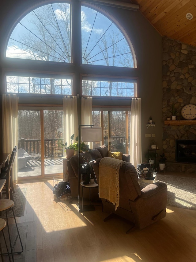 454 Wagon Wheel Dr SE Unit 17, Ten Lake Twp, MN 56601 - living room with wood finished floors, a fireplace, high vaulted ceiling, and wooden ceiling