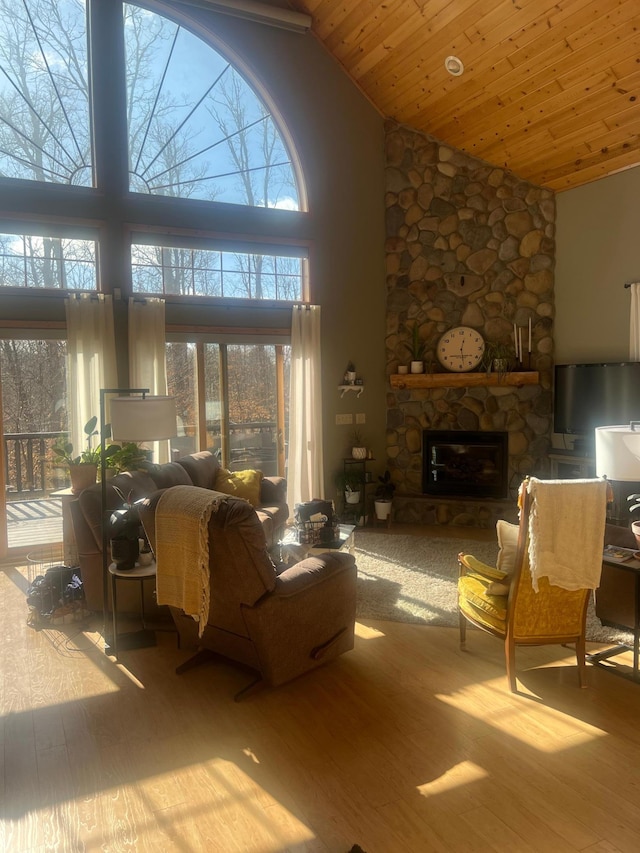 454 Wagon Wheel Dr SE Unit 17, Ten Lake Twp, MN 56601 - living room with high vaulted ceiling, wood finished floors, a fireplace, healthy amount of natural light, and wood ceiling