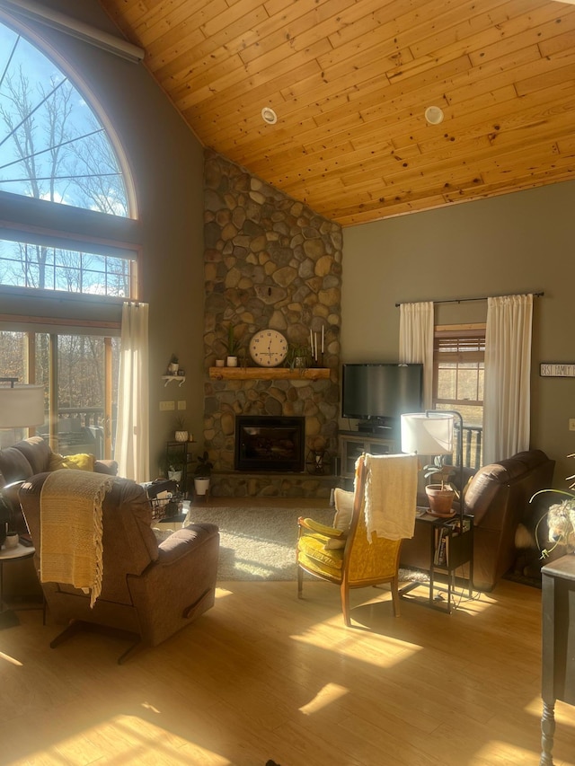 454 Wagon Wheel Dr SE Unit 17, Ten Lake Twp, MN 56601 - living area featuring high vaulted ceiling, wood finished floors, a stone fireplace, and wood ceiling