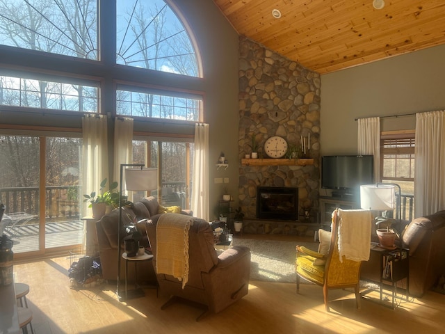 454 Wagon Wheel Dr SE Unit 17, Ten Lake Twp, MN 56601 - living area with high vaulted ceiling, wood finished floors, a stone fireplace, and wood ceiling
