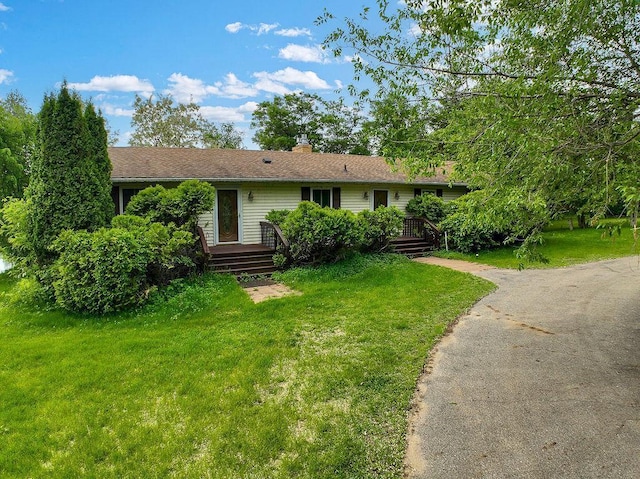 43394 Long Lake Ln, Ottertail, MN 56571 - single story home featuring a front lawn, a wooden deck, and a chimney