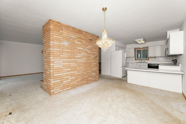 43394 Long Lake Ln, Ottertail, MN 56571 - kitchen featuring freestanding refrigerator, a chandelier, a textured ceiling, light carpet, and light countertops