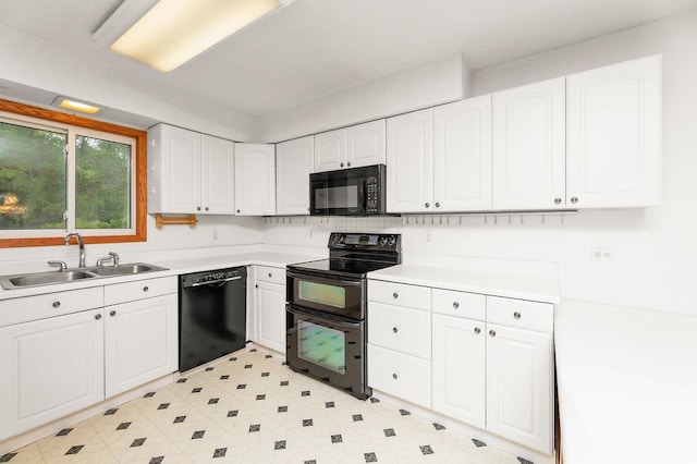 43394 Long Lake Ln, Ottertail, MN 56571 - kitchen with black appliances, white cabinets, and light countertops