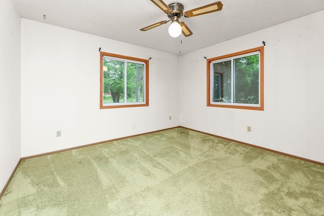 43394 Long Lake Ln, Ottertail, MN 56571 - spare room featuring carpet flooring, a ceiling fan, and a textured ceiling