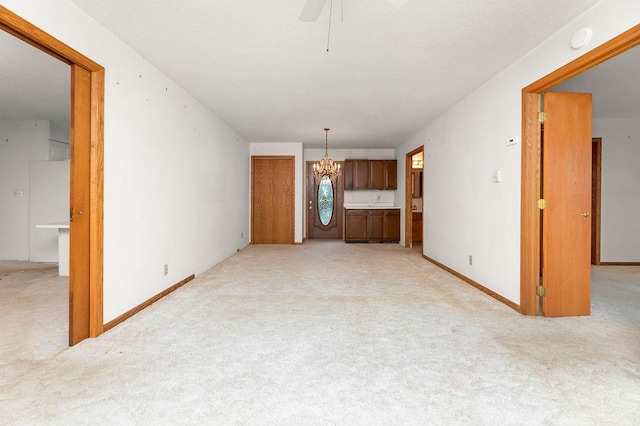 43394 Long Lake Ln, Ottertail, MN 56571 - unfurnished living room featuring a chandelier, light colored carpet, and a ceiling fan