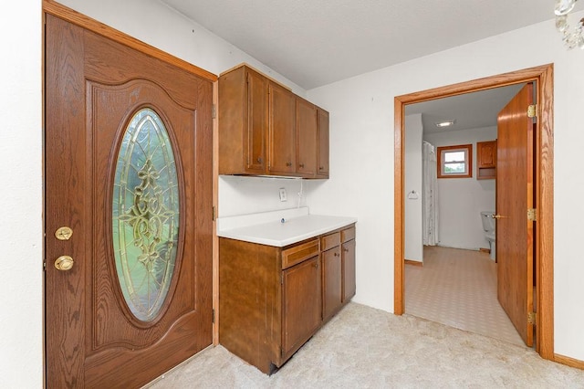 43394 Long Lake Ln, Ottertail, MN 56571 - kitchen with light countertops, brown cabinetry, and light carpet