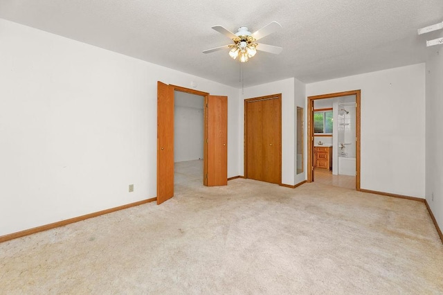 43394 Long Lake Ln, Ottertail, MN 56571 - unfurnished bedroom with carpet floors, ensuite bath, a textured ceiling, a closet, and a ceiling fan