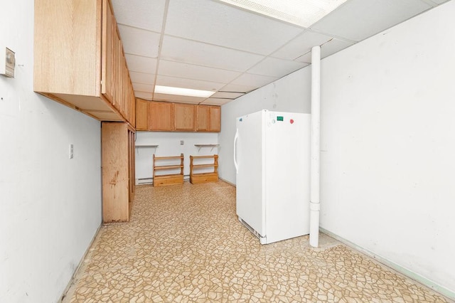 43394 Long Lake Ln, Ottertail, MN 56571 - below grade area with freestanding refrigerator, a paneled ceiling, and light floors