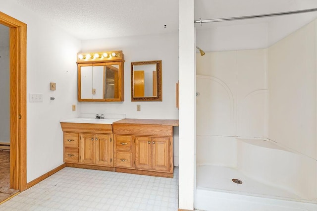 43394 Long Lake Ln, Ottertail, MN 56571 - bathroom with vanity, a shower, a textured ceiling, tile patterned floors, and a baseboard heating unit