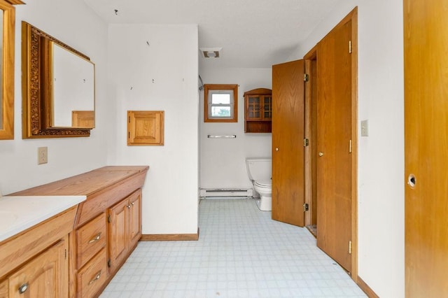 43394 Long Lake Ln, Ottertail, MN 56571 - bathroom featuring a baseboard heating unit, double vanity, and tile patterned floors