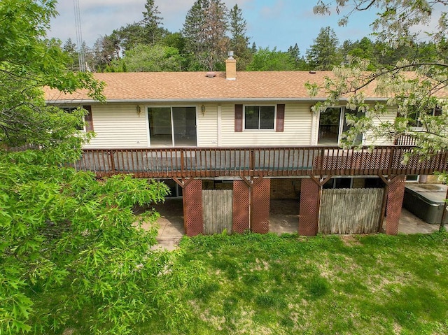 43394 Long Lake Ln, Ottertail, MN 56571 - back of house with a wooden deck, a chimney, and a lawn