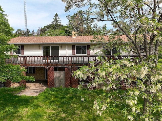 43394 Long Lake Ln, Ottertail, MN 56571 - back of house with a deck, a chimney, a lawn, and a patio area