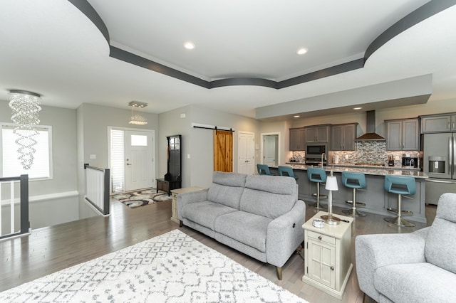 4338 Stone Crest Ln NE, Rochester, MN 55906 - living area with a barn door, light wood-style flooring, crown molding, and recessed lighting