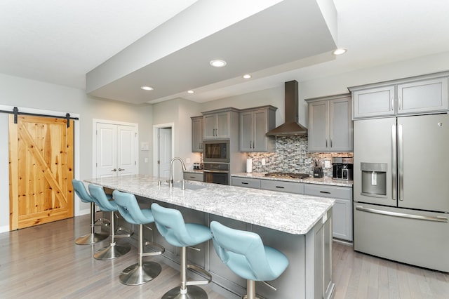 4338 Stone Crest Ln NE, Rochester, MN 55906 - kitchen with stainless steel appliances, wall chimney exhaust hood, gray cabinetry, a sink, and a kitchen breakfast bar