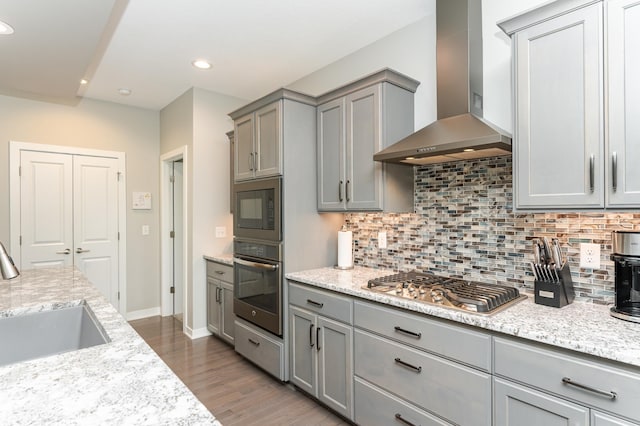 4338 Stone Crest Ln NE, Rochester, MN 55906 - kitchen with appliances with stainless steel finishes, wall chimney exhaust hood, gray cabinetry, a sink, and recessed lighting