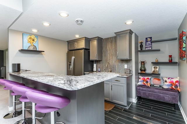 4338 Stone Crest Ln NE, Rochester, MN 55906 - kitchen featuring gray cabinetry, stainless steel refrigerator with ice dispenser, open shelves, baseboards, and recessed lighting