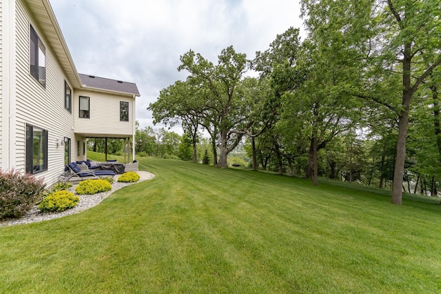 4338 Stone Crest Ln NE, Rochester, MN 55906 - view of grassy yard with an outdoor hangout area, a patio area, and view of wooded area