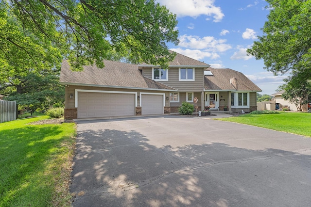 14023 Yellow Pine St NW, Andover, MN 55304 - view of front of house with a garage, asphalt driveway, brick siding, and roof with shingles