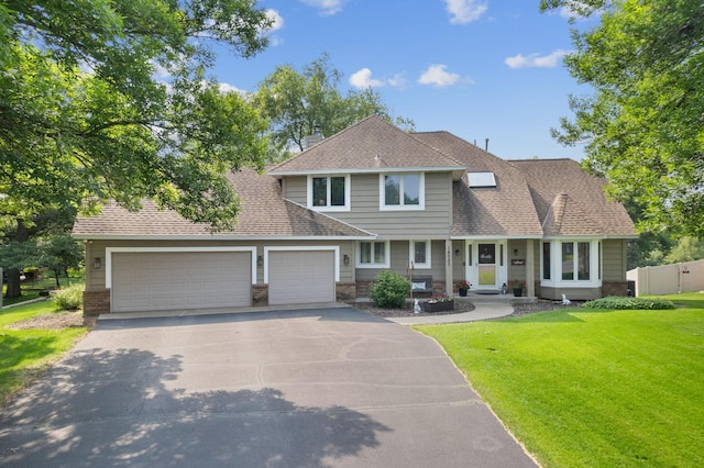 14023 Yellow Pine St NW, Andover, MN 55304 - view of front of house with an attached garage, driveway, and roof with shingles