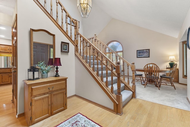 14023 Yellow Pine St NW, Andover, MN 55304 - staircase with wood finished floors, high vaulted ceiling, and a chandelier