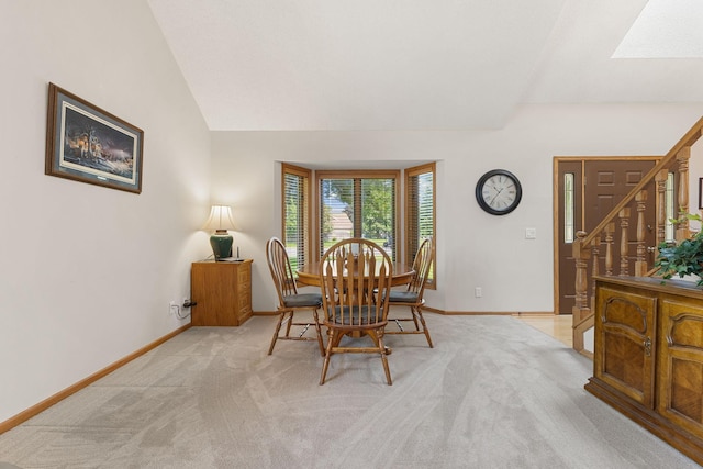 14023 Yellow Pine St NW, Andover, MN 55304 - dining space with light carpet, stairs, vaulted ceiling, and a skylight